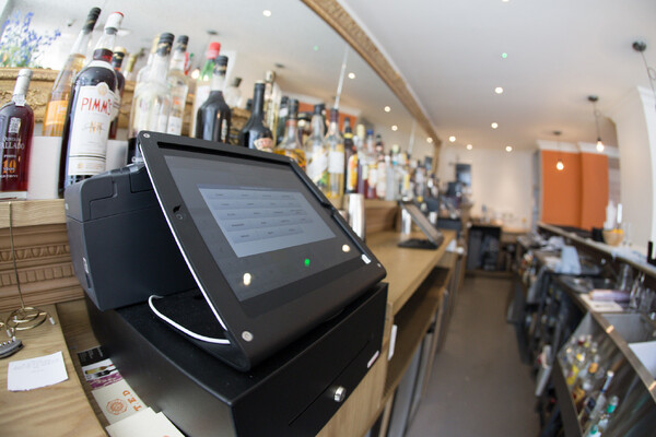 A point of sale terminal on a bar during service